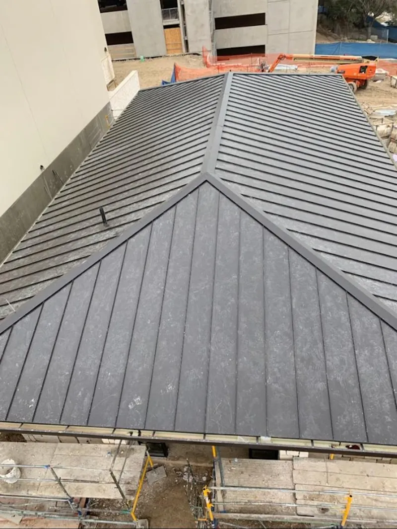 Commercial metal roof construction with crane equipment in Holtville